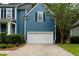 Attached garage with an asphalt driveway complemented by mature landscaping at 3574 Toomer Kiln Cir, Mount Pleasant, SC 29466