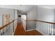 Upstairs hallway with hardwood floors and white railings offering a bright transition space at 3574 Toomer Kiln Cir, Mount Pleasant, SC 29466