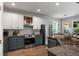 Bright kitchen featuring stainless steel appliances and wooden floors with an adjoining dining area at 3574 Toomer Kiln Cir, Mount Pleasant, SC 29466
