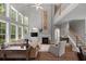 Open living room featuring high ceilings, fireplace, large windows, and hardwood floors at 3574 Toomer Kiln Cir, Mount Pleasant, SC 29466