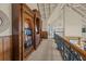 Spacious upstairs hallway features custom wood shelving, carpet, and views of the open living space at 377 Lofton Ct, McClellanville, SC 29458