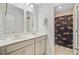 Bright bathroom featuring dual sinks, gray cabinets, and a shower with a curtain at 3798 Sawmill Ct, Mount Pleasant, SC 29429