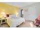 Cozy bedroom with yellow accent wall, white bedding and ensuite bathroom at 3798 Sawmill Ct, Mount Pleasant, SC 29429