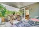 A cozy covered porch with seating area and views of the yard at 3798 Sawmill Ct, Mount Pleasant, SC 29429