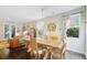 Sunlit dining room with hardwood floors, modern lighting, and comfortable seating at 3798 Sawmill Ct, Mount Pleasant, SC 29429