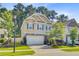 Beautiful view of a charming two-story home with a two-car garage and nicely landscaped front yard at 3798 Sawmill Ct, Mount Pleasant, SC 29429