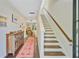 Bright foyer featuring hardwood floors, stairs, and stylish decor at 3798 Sawmill Ct, Mount Pleasant, SC 29429