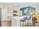 Bright kitchen featuring white quartz countertops, stainless appliances, and stylish breakfast bar seating at 3798 Sawmill Ct, Mount Pleasant, SC 29429