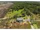 An aerial view of the charming home featuring serene natural surroundings with lush green trees and marshland at 3810 Marshfield Rd, Johns Island, SC 29455