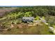 An aerial perspective of a charming home with a front porch, surrounded by nature and trees at 3810 Marshfield Rd, Johns Island, SC 29455