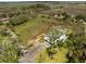 An aerial view of the property showcasing a spacious yard with trees, near water, and neighboring homes nearby at 3810 Marshfield Rd, Johns Island, SC 29455