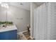Bathroom featuring blue vanity, patterned shower curtain, and wood floors at 3810 Marshfield Rd, Johns Island, SC 29455