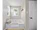 Bright bathroom featuring white soaking tub with jets and window at 3810 Marshfield Rd, Johns Island, SC 29455