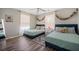 Bedroom featuring two beds, wood floors, and bright windows at 3810 Marshfield Rd, Johns Island, SC 29455