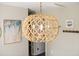 Close-up of the unique woven pendant light fixture with a view of the dining area at 3810 Marshfield Rd, Johns Island, SC 29455