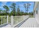 Deck with white railings overlooking scenic wooded area at 3810 Marshfield Rd, Johns Island, SC 29455