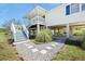 A house on stilts with a staircase leading up to a porch and surrounded by natural beauty at 3810 Marshfield Rd, Johns Island, SC 29455