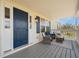 Cozy front porch area with comfortable seating, a stylish rug, and a welcoming blue front door at 3810 Marshfield Rd, Johns Island, SC 29455