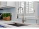 Close-up of the kitchen sink with a modern faucet and window views at 3810 Marshfield Rd, Johns Island, SC 29455