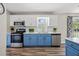 Modern kitchen featuring stainless steel appliances, blue and white cabinets, and ample counter space at 3810 Marshfield Rd, Johns Island, SC 29455