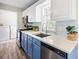 Well-lit kitchen with a stainless steel sink, two-tone cabinets, and modern backsplash at 3810 Marshfield Rd, Johns Island, SC 29455