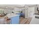 Bright kitchen with blue and white cabinetry, stainless steel appliances, and wood-look flooring at 3810 Marshfield Rd, Johns Island, SC 29455