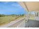 Relaxing front porch featuring scenic views of the marshland, perfect for enjoying the peaceful outdoors at 3810 Marshfield Rd, Johns Island, SC 29455