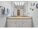 Bright bathroom with a double sink vanity, decorative mirror, and sea-themed decor at 40 Greensward Rd, Kiawah Island, SC 29455