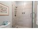 Walk-in shower with tile surround, glass doors, and toiletry shelf at 40 Greensward Rd, Kiawah Island, SC 29455