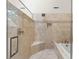 Elegant bathroom with frameless shower, soaking tub, and neutral tile at 40 Greensward Rd, Kiawah Island, SC 29455