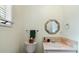 Powder room features a stylish mirror, elegant sink, and a window with natural light at 40 Greensward Rd, Kiawah Island, SC 29455