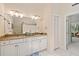 Bathroom with granite countertops, double vanity, and a view into an adjacent room at 40 Greensward Rd, Kiawah Island, SC 29455