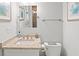 Bright bathroom featuring a single sink, granite countertop, toilet, and decorative art at 40 Greensward Rd, Kiawah Island, SC 29455