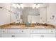 Well-lit bathroom featuring a double vanity with granite countertops, modern fixtures, and a large mirror at 40 Greensward Rd, Kiawah Island, SC 29455
