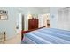 Bedroom with wooden queen bed and view to kitchen and second bedroom at 40 Greensward Rd, Kiawah Island, SC 29455