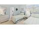 Bright, cozy bedroom with two twin beds, wicker dresser, and doorway to bathroom at 40 Greensward Rd, Kiawah Island, SC 29455