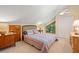 Cozy bedroom features a sloped ceiling, ceiling fan, and bright natural light from large window at 40 Greensward Rd, Kiawah Island, SC 29455