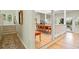 Bright dining room with hardwood floors, a skylight, and a view to the living room at 40 Greensward Rd, Kiawah Island, SC 29455