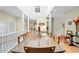 Dining room filled with natural light through clerestory windows, wood floors, and views into other rooms at 40 Greensward Rd, Kiawah Island, SC 29455