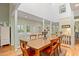 Bright dining room with hardwood floors, a large table, and views to the backyard through windows and glass doors at 40 Greensward Rd, Kiawah Island, SC 29455