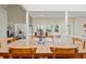 Bright dining area boasts hardwood floors, skylight, a glass top table, and views to a covered patio at 40 Greensward Rd, Kiawah Island, SC 29455