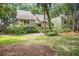 Charming exterior of home surrounded by lush landscaping and mature trees providing shade and character at 40 Greensward Rd, Kiawah Island, SC 29455