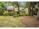 Attractive home with well-maintained landscaping, a spacious front lawn, and mature trees at 40 Greensward Rd, Kiawah Island, SC 29455