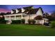 Charming home with lush landscaping, a covered porch, and a convenient golf cart garage at 40 Greensward Rd, Kiawah Island, SC 29455