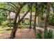 Exterior of home boasts mature trees, established landscaping, and a welcoming walkway at 40 Greensward Rd, Kiawah Island, SC 29455