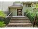 Inviting entryway with brick steps, metal railings, and a solid front door with glass panels at 40 Greensward Rd, Kiawah Island, SC 29455