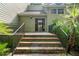 Charming entryway with brick steps, metal railings, and a front door with glass panels at 40 Greensward Rd, Kiawah Island, SC 29455