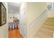 Hallway with view of kitchen, featuring stairs with carpet, door, and hardwood flooring at 40 Greensward Rd, Kiawah Island, SC 29455