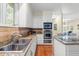 Well lit kitchen with granite countertops, stainless steel appliances, and hardwood floors at 40 Greensward Rd, Kiawah Island, SC 29455