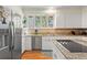 Bright kitchen with stainless steel appliances, backsplash and double sink at 40 Greensward Rd, Kiawah Island, SC 29455